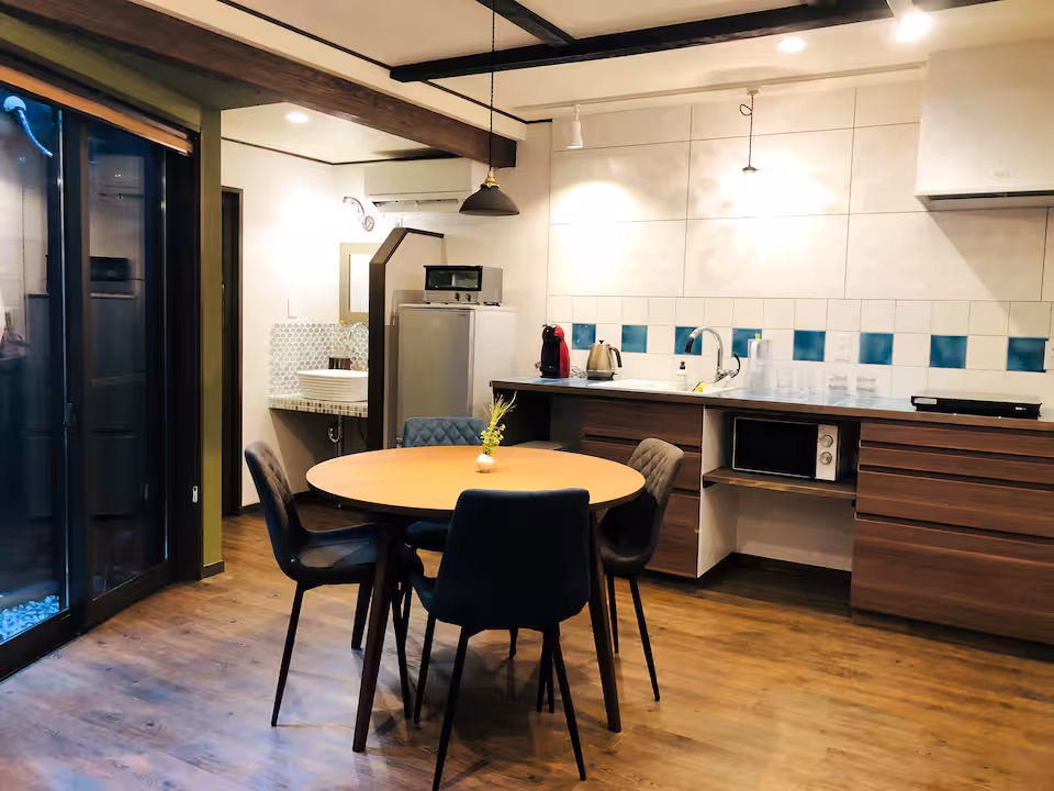 Fune cottage dining area with a round table and an open kitchen
