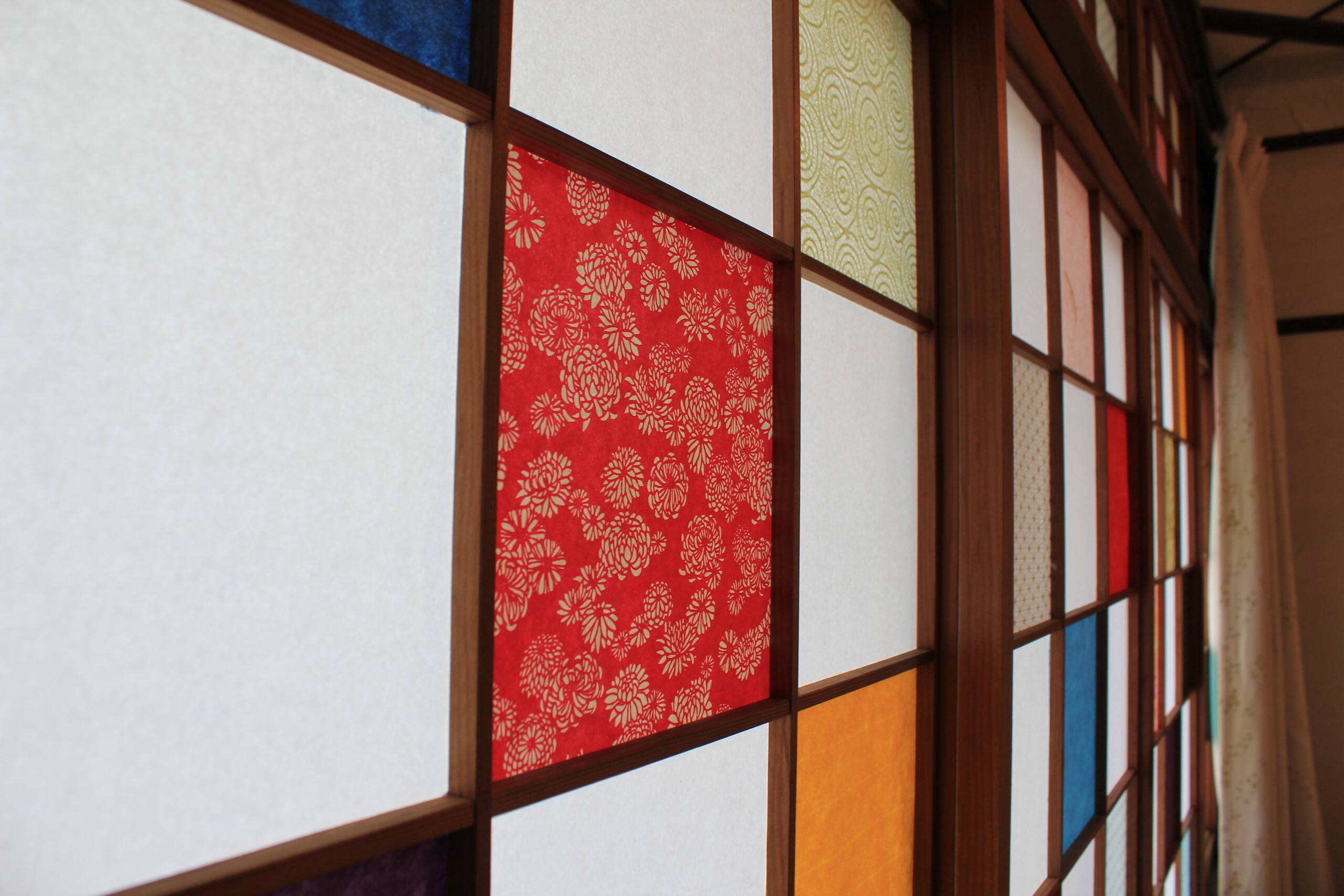 Close-up of San's shoji screens with red and coloured patterned paper panels