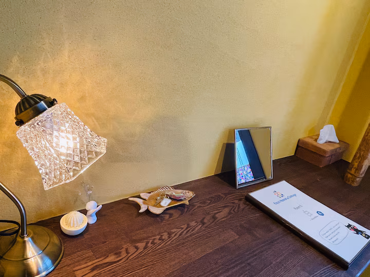 Desk in Shiro room with a glass table lamp and the guest book
